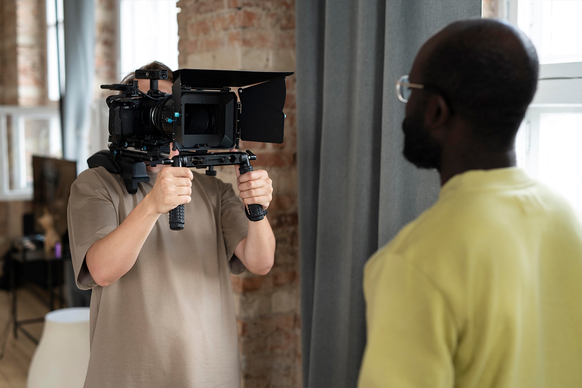 Camera professional filming an interview